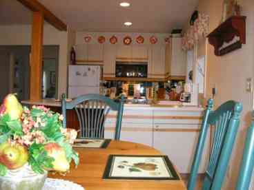 New England Rental house - dining rea by large deck looking into full kitchen
