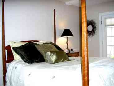 Master bedroom with four poster in New England rental house