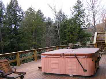 Hot tub on expansive deck of New England rental home