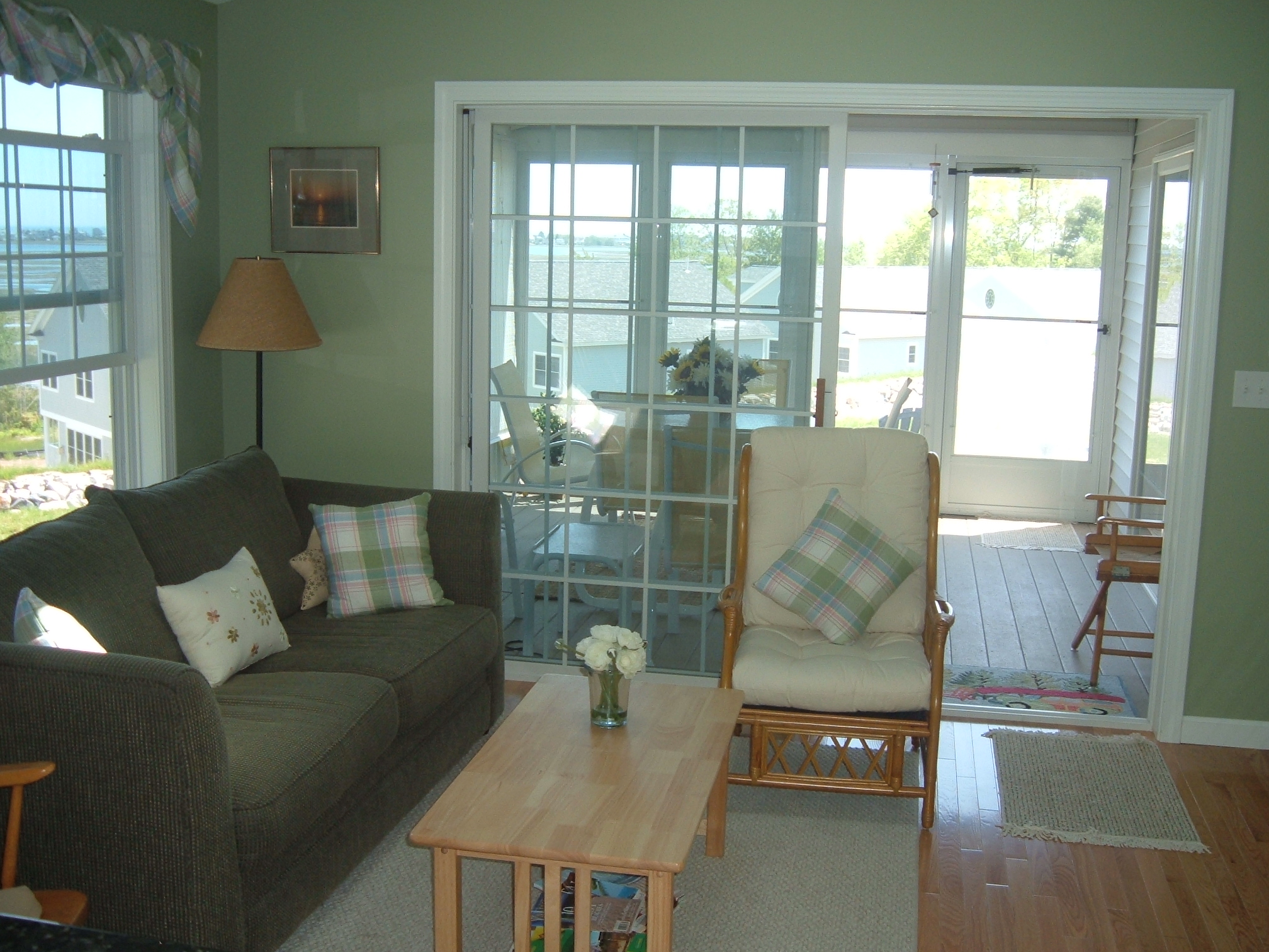Beautiful hardwood floors and slider leading out to the screened porch. There is a flat-panel TV in the Living room.