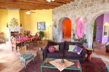 Great room with fireplace, living area, and formal dining table for 12.