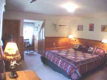 Wonderful living room with leather couches, Pendleton covered chairs, stereo with cd player, tv, vcr & dvd player