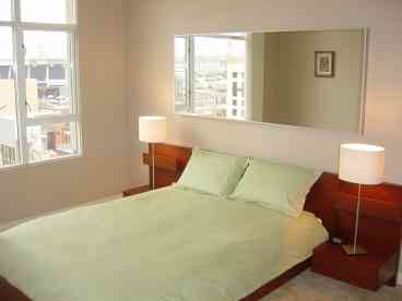 Beautiful Master bedroom with views into PETCO Park. 
