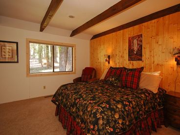 Fabulous master suite with forest views, sitting area, desk and king bed