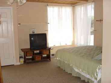 A huge second story room with an amazing view of the beach!  1 queen, 1 twin, walk-in closet and full bathroom.  Patio attached through sliding glass door.