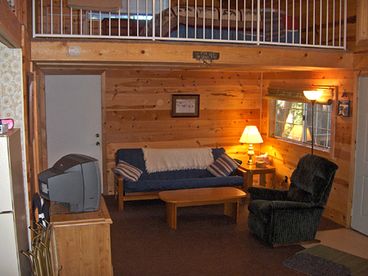 North side of the living room features a futon/sleeper couch