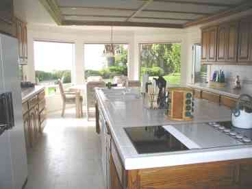 Huge eat in fully equipped gourmet kitchen with ocean views.  Adjoins living room and formal dining room.