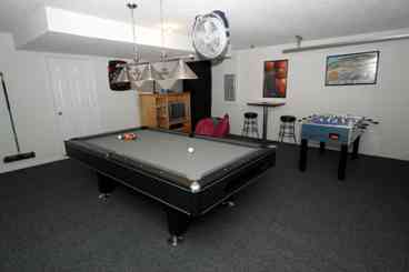 Games Room with professional pool/snooker tabel, playstation 2, electronic dart board and football table with seating area.