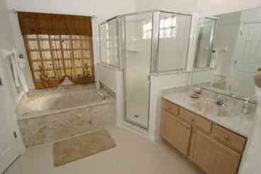 Master Suite Marble Bathroom with twin vanities walk in shower oval tub and seperate w.c.