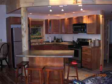 Fully equipped chef kitchen with island seating ideal for socializing