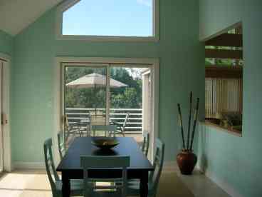 Large dining room with sliding glass doors to decks.