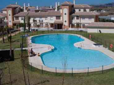 Large communal swimming pool open during the summer months situated in the centre of the complex serviced with showers and toilets and surrounded by grassy sun-bathing area. A second garden area contains a children\'s playground and a paddle tennis court.