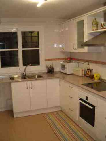 A modern, high-quality kitchen equipped with ceramic hob, oven, dishwasher, microwave, and fridge-freezer. A toaster is also provided. Door leading to Utility area: Contains a sink, washing machine and tumble dryer. Back door leading out to paved area furnished with a table and chairs, perfect for catching the morning sun over breakfast. 
