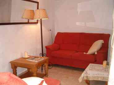 Lounge/Dining area: Good-sized wooden dining table with 4 chairs situated separately from the comfortable seating area furnished with two sofas. 