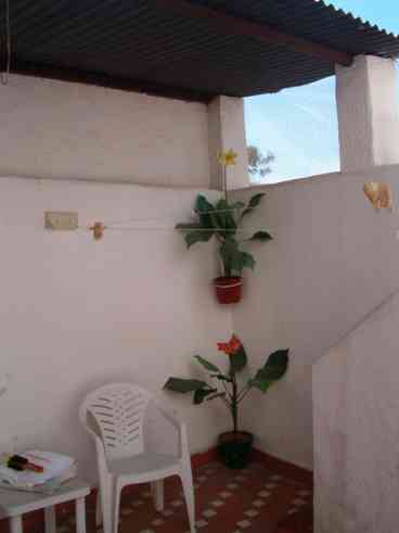 Partially covered courtyard leading off the kitchen leads up to a sunny south and west facing roof terrace.
