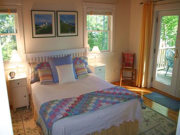 Main floor queen bedroom with adjoining full bath -- Glass doors open to deck with view of ocean. Radiant floor heat.