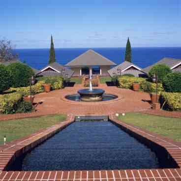 Brick walks meander through 5 1/2 acres of lush tropical landscape, sparkling fountains, pools and cascading waterfalls.