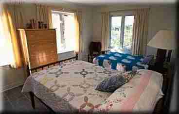 Two antique double beds, hand made quilts and a fabulous view make for a very special room  