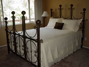 Our Crystal Hill room has a view of the river and an antique brass bed.