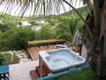 a beautiful jaccuzzi with a spectacular view and a tanning deck privately secluded just for you