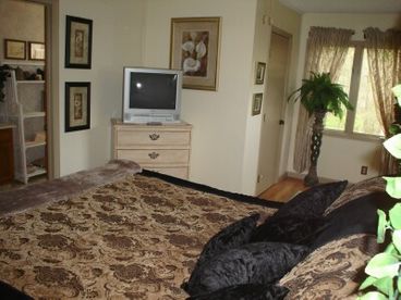 Your sumptuous master bedroom suite has a luxury top quality king bed with 400 count sheets and ultra soft blankets.  Attached private bathroom. Watch TV/DVD/VCR from bed.  There are 2 walk-in closets.