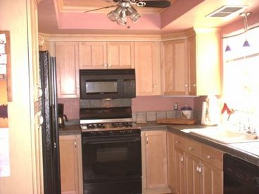 Kitchen looks out to the gardens and pool