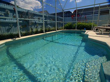 South facing pool and spa surrounded by beach themed privacy fence. Plenty of luxury padded pool furniture and the whole area is screened.