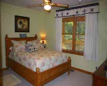 Master bedroom has queen size bed, TV w/ Directv and Dvd, w/ adjoiningt1/2 bath.