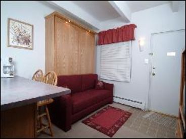 Queen Murphy wall bed folds over sofa after removing cushions. Not shown is lift-top coffee table.