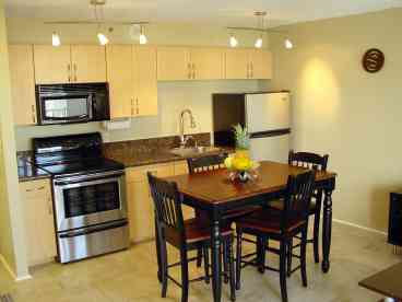 Luxury Kitchen.  Stainless steel fridge and stove.  Designer fixtures.
