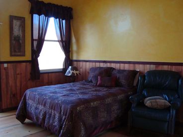 downstairs, bed and seating area.