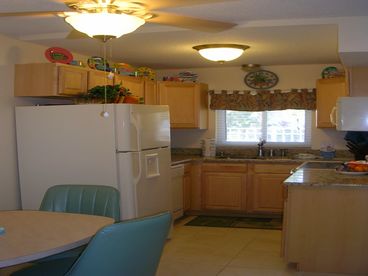 KITCHEN OVERLOOKING TROPICAL POOL AND PATIO