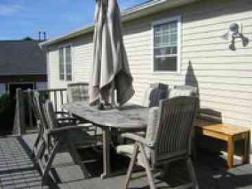 Large Teak Outdoor Table with 6 teak chairs and bench.  Along with BBQ for dining.