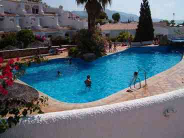 Large communal swimming pool open during the summer months situated adjacent to the apartment, serviced with showers and toilets,a pool bar and surrounded by tiled sun-bathing area. 
