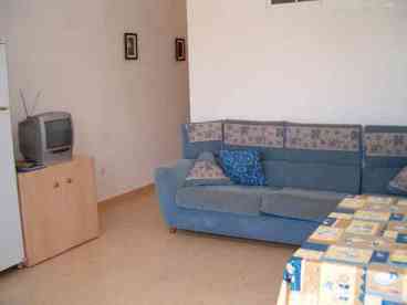 Good size bright open-plan lounge/diner with doors to the sunny terrace and garden, furnished with a comfortable corner sofa and colour TV, radio/cassette/CD player and a table and 4 chairs.