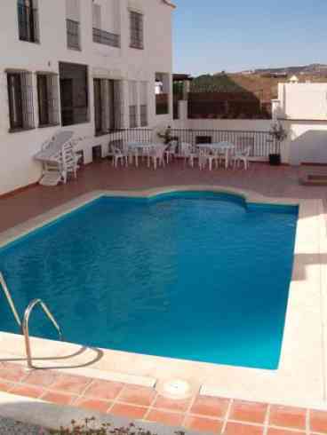 Swimming pool, shower and sunbathing area with views to countryside. 

