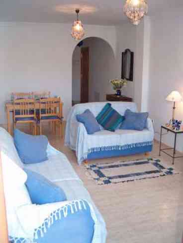 Spacious contemporary open-plan lounge/diner furnished with dining table and four chairs, two sofas, side tables & U.K. satellite TV. Doors to large terrace and country views. Radiators for winter & fans for summer are also provided.