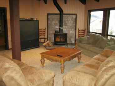 Living Room has a large screen TV with cable, wood burning fireplace and lakeview.