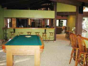 Game room opens to the kitchen and the wet bar.  Deck off of this game room has a BBQ and fire pit.