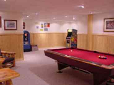 Game room with pool table and arcade games