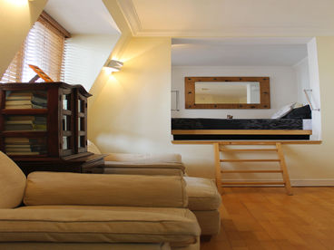 View from the bed to the upstairs sitting area and bathroom