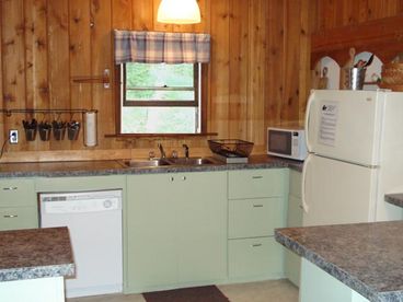 The kitchen has a dishwasher, microwave, toaster, coffee maker and ice cream maker. 