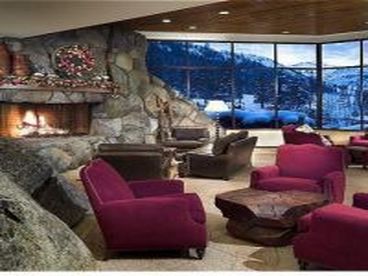 Lobby has massive wood burning fireplace with lounging areas and game tables. It overlooks the pools, spas, Ice Rink, and Ski Area.