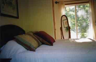bed room with one queen size bed. French door offering river view and access to rear yard.