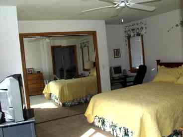 Master bedroom is average size and has a queen bed.