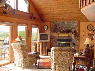 Main level living room with Bose Surround Sound. 2 Deluxe Laz-Boy recliners & sofa. Relax in front of the true wood burning stone fireplace-we supply the wood!