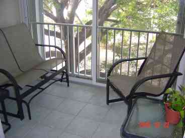 Balcony overlooking pool with sliding glass & screen doors