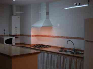 Kitchen area: Open plan kitchen area equipped with gas hob, double sink, microwave, fridge-freezer, and washing machine. A kettle, coffee-maker, toaster, iron and ironing-board are also provided. 

