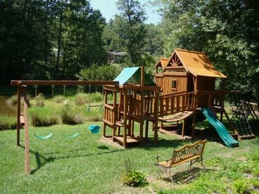 Two forts, slides, swings, climbing wall, clatter bridge, tire swing provides hours of fun!  Sits beside the lake.
