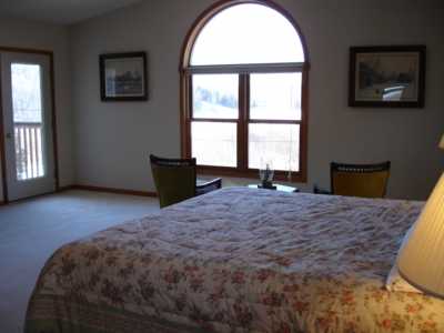 Master BR with 2nd floor deck access and view of lake.